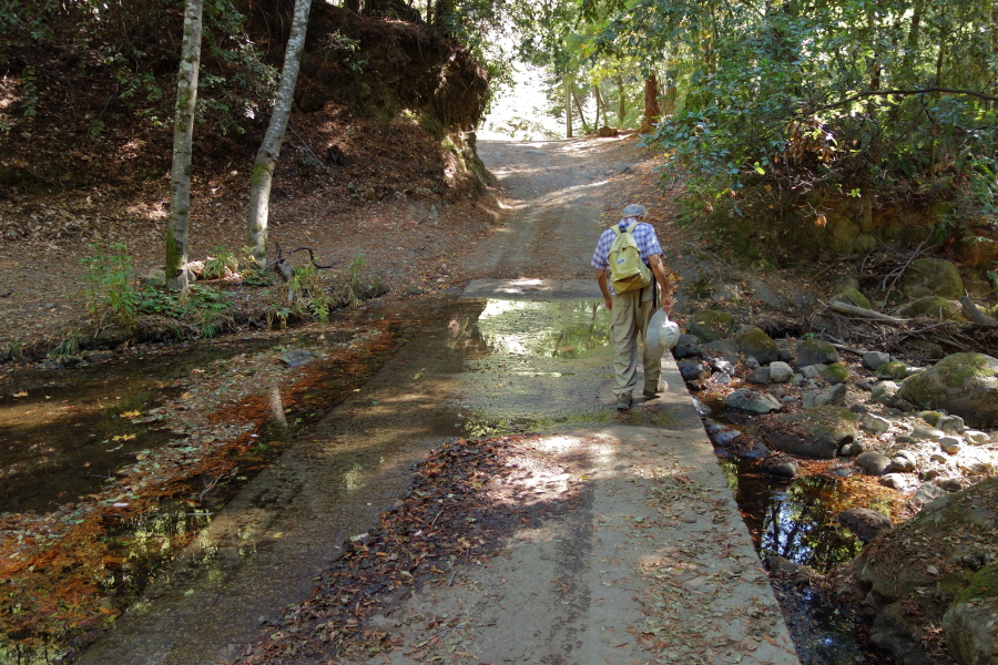 David crosses the paved ford through Kings Creek.