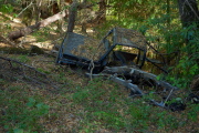 A wrecked jeep off the side of the road