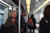 Travelers entering the Skylink train.
