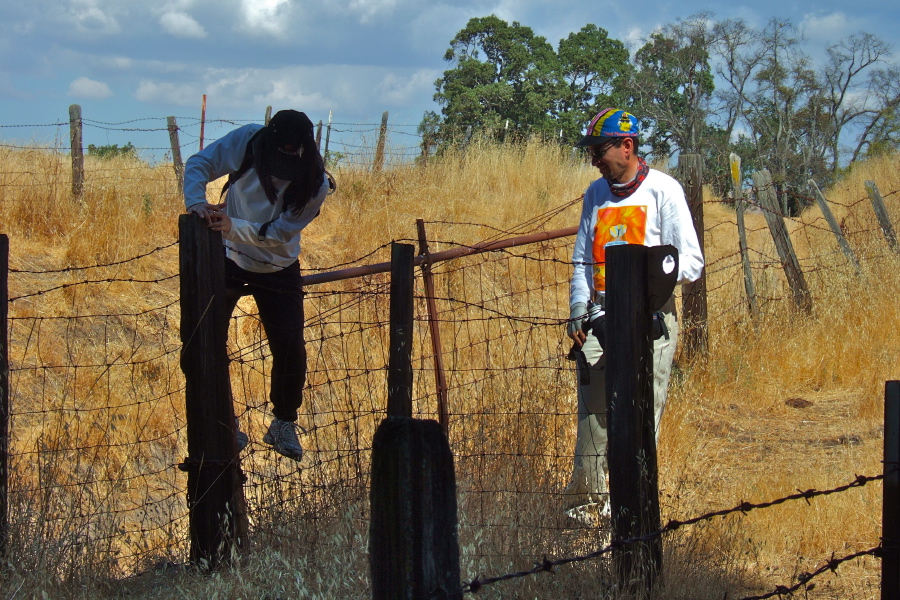 Michi follows Ron over the gate while Zach looks on.