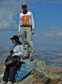 Zach stands and Michi sits on the summit pinnacle.