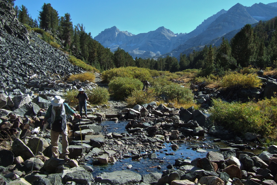 Frank and Stella cross the creek on flat stones.