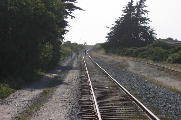 Ed, Laura, and Michael hiking along the train tracks.