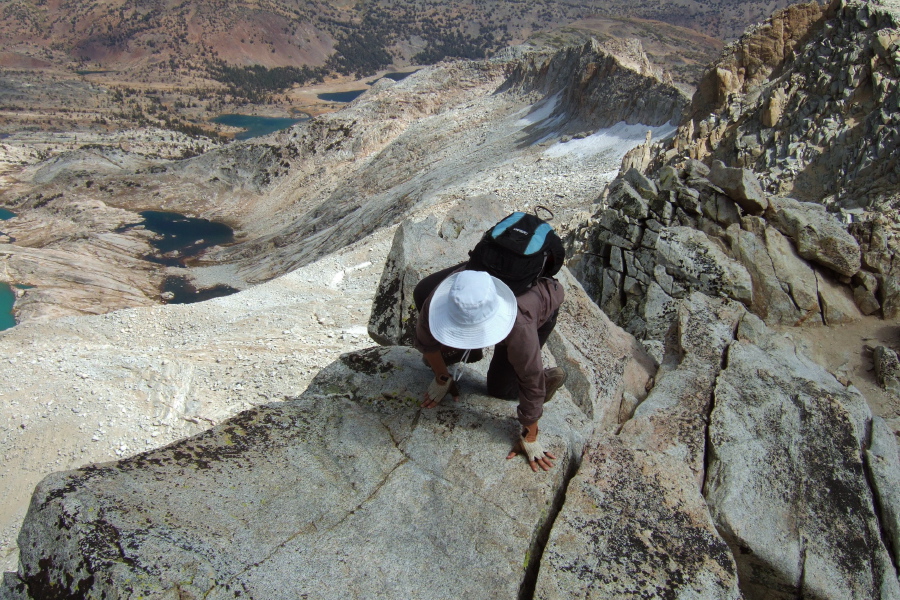 Stella musters courage to climb atop the rock on the edge of the abyss.