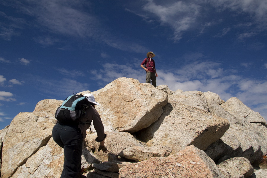 Bill surveys the surrounding land while Stella makes her move for the summit.