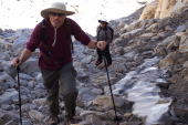 Bill heaves himself up through the rocks, while Stella looks on amused.