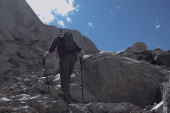 Bill presses on up the steep rock pile.