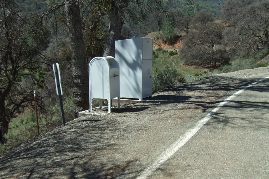 Whitewashed mailboxes and package receptacles on Mines Road