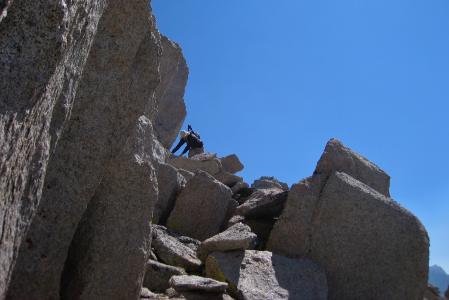 Bill scrambles down from the south summit.