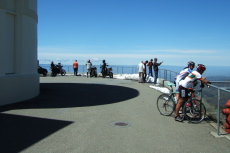 Visitors to the summit enjoy the view and the remaining snow.