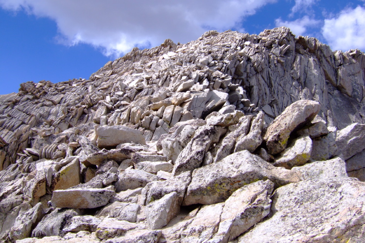 The route to the summit appears to be a scramble up the boulders.