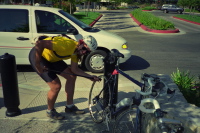 Richard re-inflates his tire after fixing a flat.
