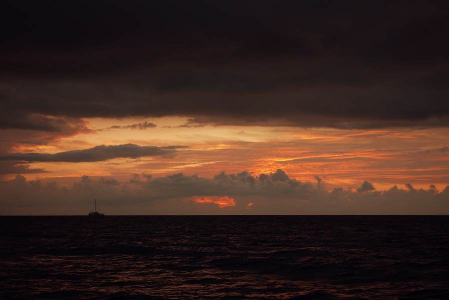 Another tour boat pauses to watch the sun set.