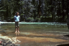 Laura ventures into the water of the Merced.