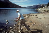 David skips stones on Tenaya Lake.