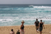 Laura and others watch the surfers on the big waves at Sunset Beach.