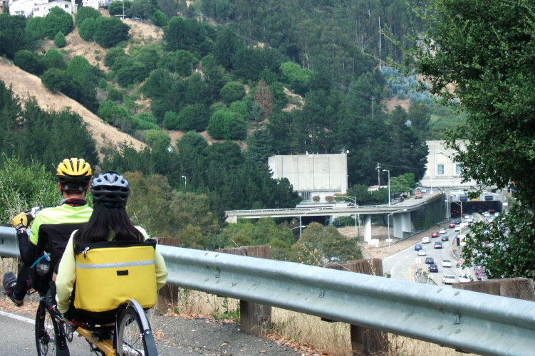 Zach and Michi climb Tunnel Rd. near the Caldicott Tunnel (background).