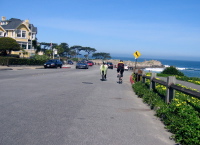 Ron and Randall ride Ocean View Blvd. in front of the Seven Gables Inn