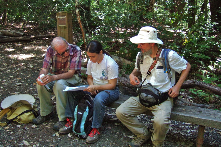 David, Stella, and Frank take a look at the map while resting at the top of the Crystal Springs Trail.