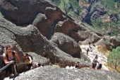 Many people climb the long rock stairway.