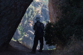 Frank stands in the rock window.