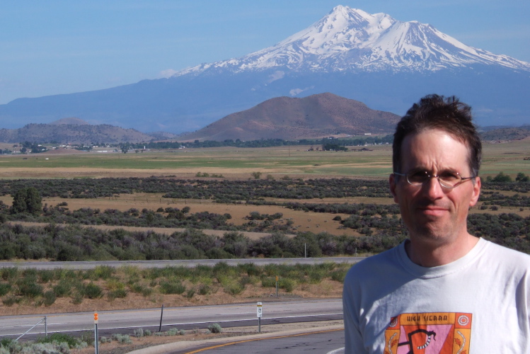 Bill in front of Mt. Shasta (14162ft) from southbound I-5 near Yreka, CA.