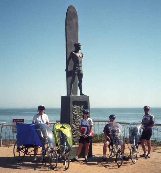 Recumbent riders and Lisa Antonino at the Santa Cruz surfer statue.