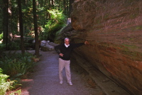 David stands next to a fallen redwood.