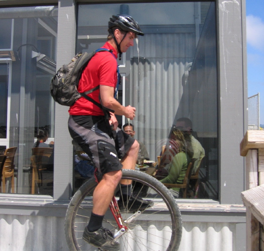 A unicyclist leaves the restaurant at Moss Landing.