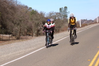 Lisa Antonino and T Lynch, and another cyclist reach Rabbit Summit.