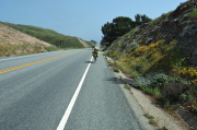 Zach rides south on CA1 above the bluffs near Greyhound Rock.