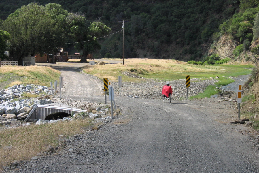 Ron crosses the culvert marking where the road turns to dirt. (1450ft)
