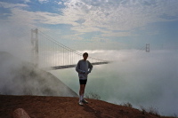 Bill at the Marin Headlands with fog pushing over the deck of the Golden Gate Bridge.