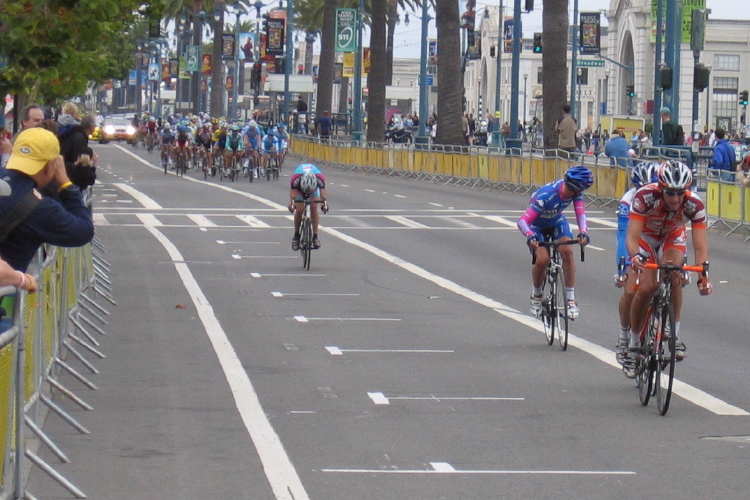 The last of the chasers with the peloton bearing down on them.