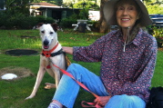 Kay and the shelter dog on a lawn.