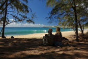 David and Kay relax under the ironwood pines at Keoniloa (Shipwreck) Beach