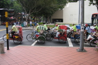 Tourists in bicycle rickshaws at North Beach and Bras Basah Roads