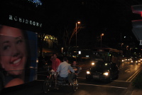 Pedicab driver hauling three overweight tourists on Stamford Rd.
