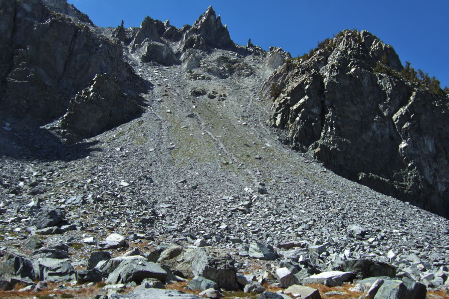 Frank prefers to struggle through the talus at the base of this broad chute.