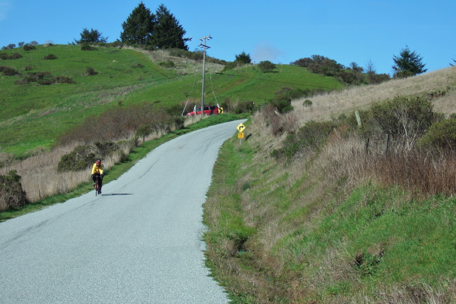 A tandem descends the short, steep hill on Cloverdale Rd.