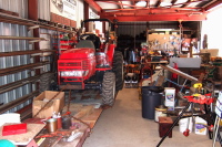 Workshop with tractor on flat car.