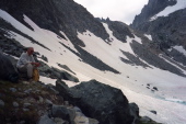 The trail to Cecile Lake climbs across the snowfield and up the headwall in the background.