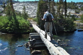 David leads the way over the high footbridge above the headwaters of the San Joaquin River, the outflow from Thousand Island Lake.