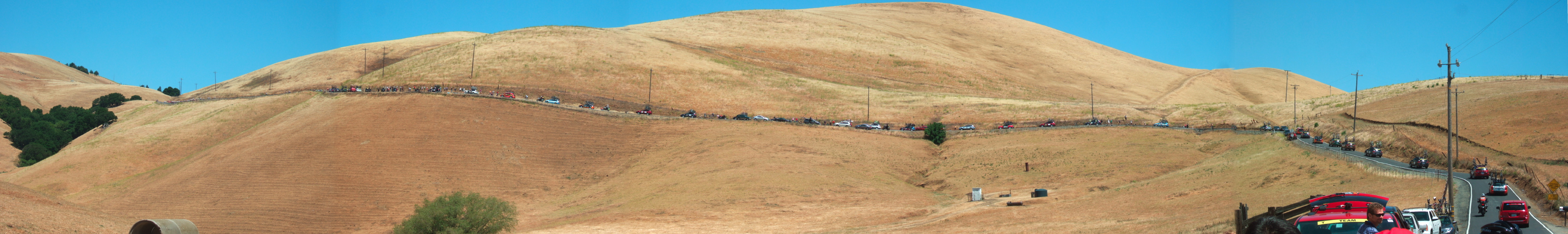 The peloton and support vehicles wind their way up Morgan Territory Road.