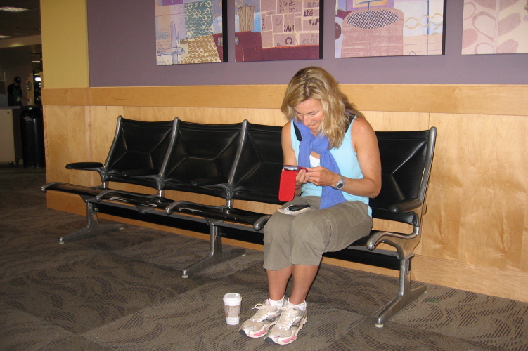 Laura checks her Crackberry while we wait to board our plane to Maui.