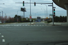 Confusing signs at an intersection near the airport