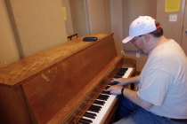 Len plays through Clair de Lune on one of the well-used practice room pianos.