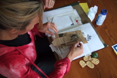 Laura looks through an old NY Times clipping announcing her grandmother's wedding.