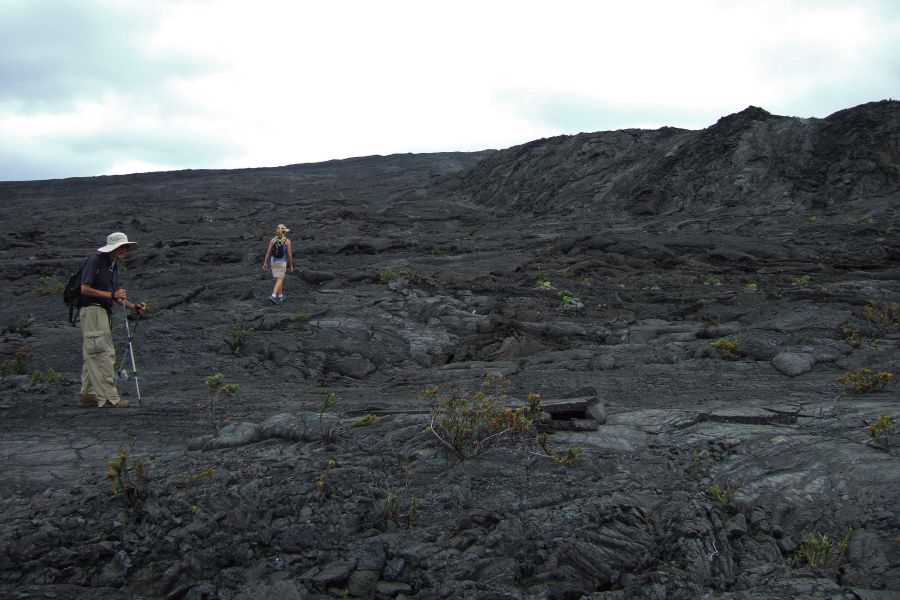 Laura marches up the flank of Mauna Ulu while David pauses.