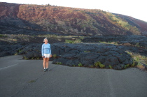 Laura stands before a lava flow that covered the old Chain of Craters Road.